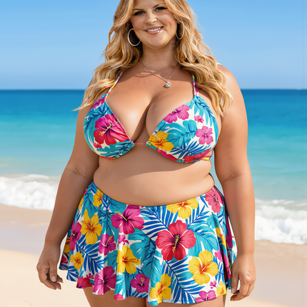 Plus size blonde woman wearing a colourful floral tankini set on a sunny beach